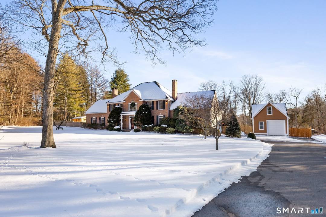 This stately Colonial tucked away at the end of a cul de sac in Easton, blends classic architecture with resort style living.