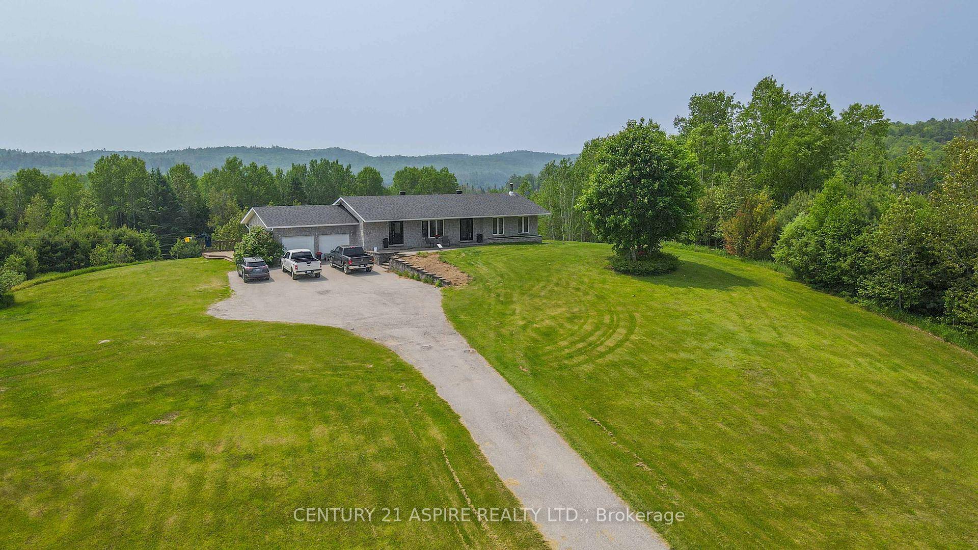 Nestled atop a picturesque hill, just over 6 acres of private property offers breathtaking views of surrounding lands and valleys just outside of quaint and charming Palmer Rapids.