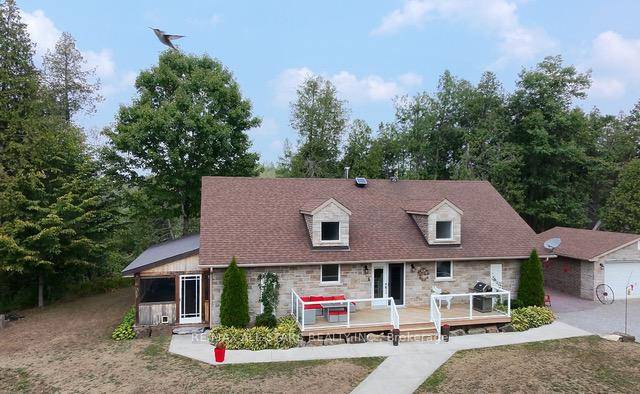A TRULY REMARKABLE PROPERY This stunning brick and stone bungalow sits on a 50 acre lot, offering the perfect blend of elegance and tranquility.