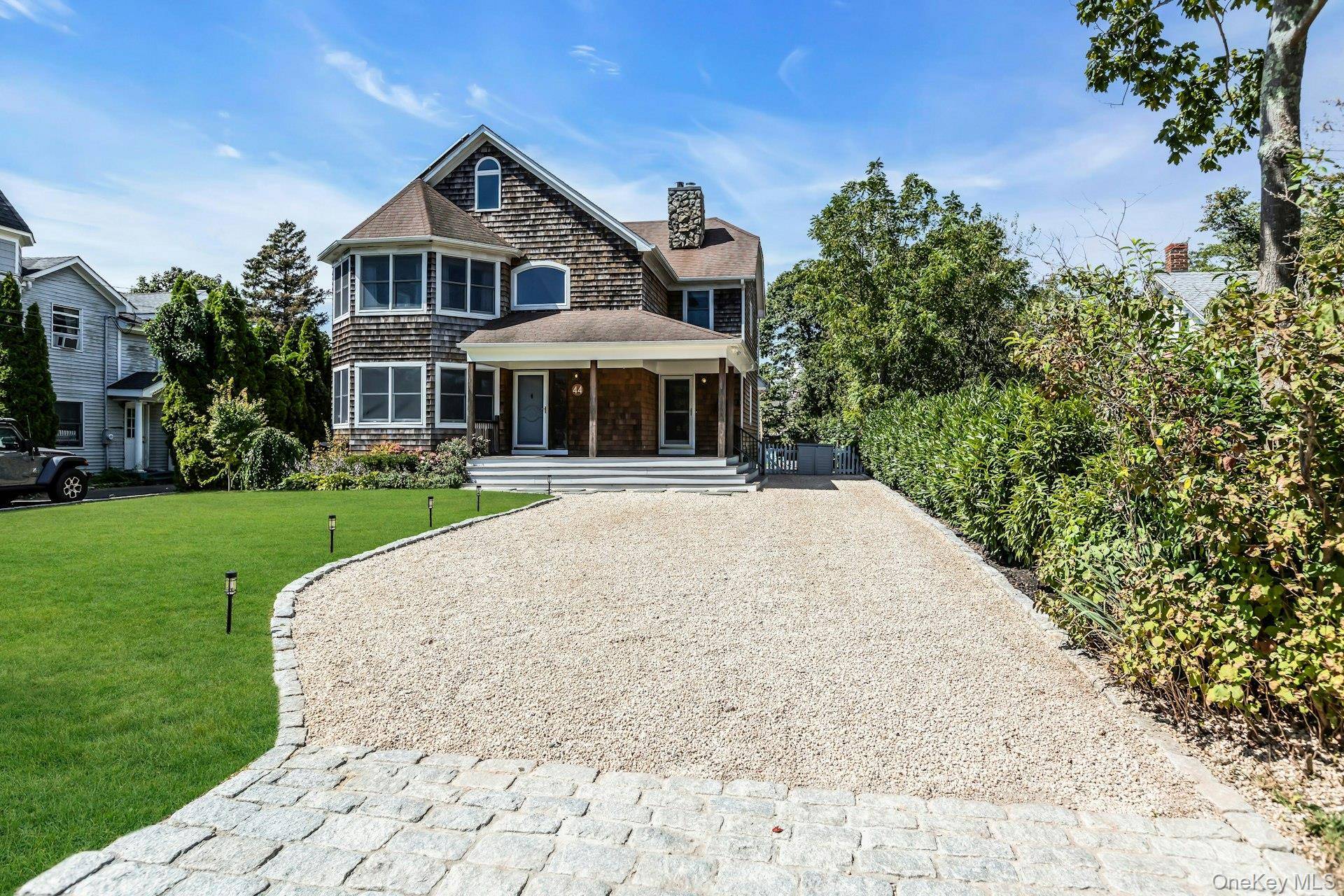 Welcome to this charming cedar shake traditional in the heart of South Bayport, where timeless design meets modern comfort.