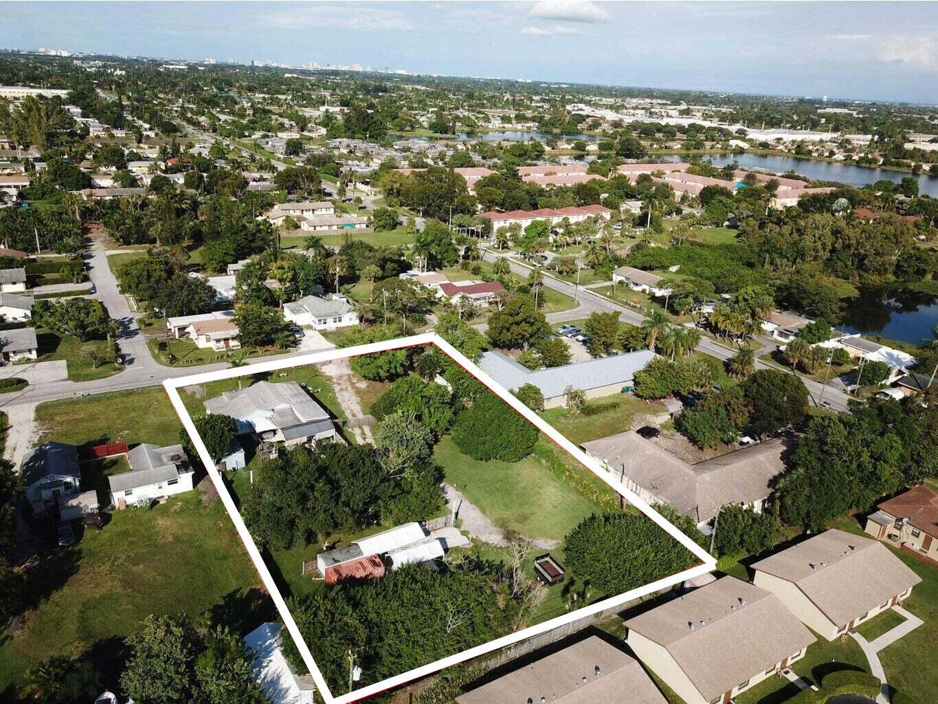RARE DEVELOPMENT OPPORTUNITY Unlock the potential of this nearly 1 acre private lot in the heart of Palm Springs, FL !