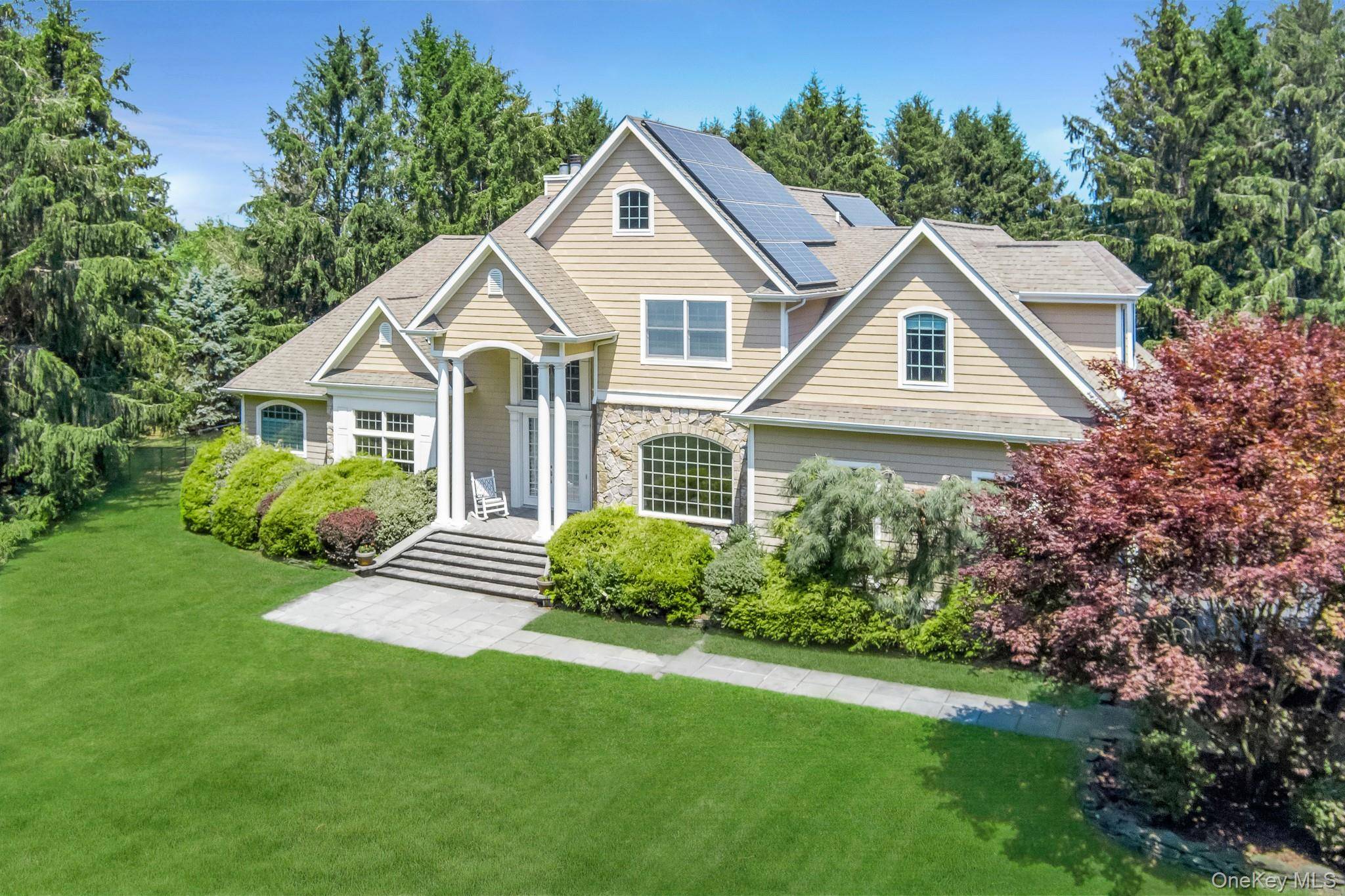 Welcome to your private North Fork retreat nestled on nearly 2 lush, level acres in the heart of Cutchogue, this beautifully maintained 4 bedroom, 2.