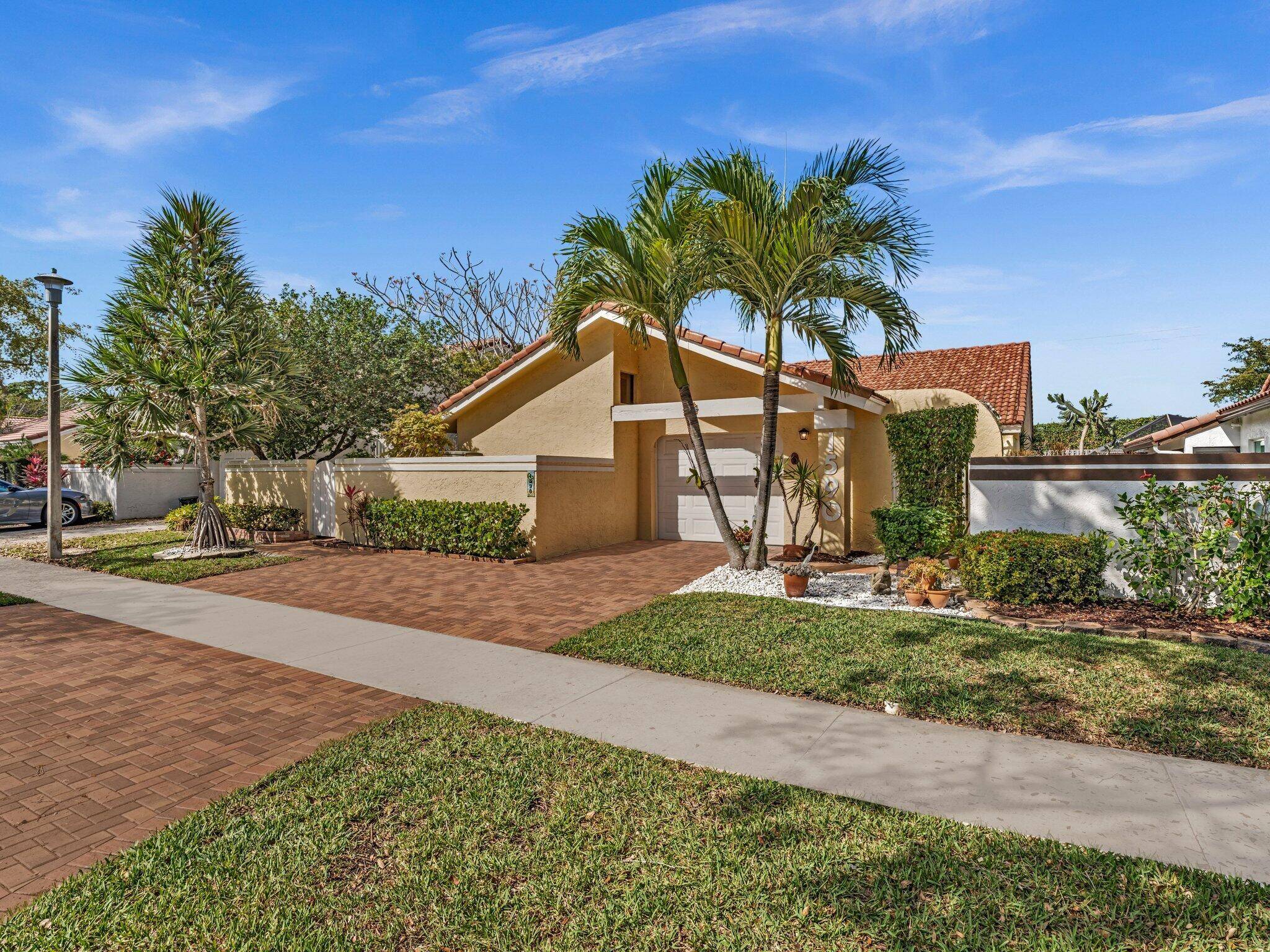 Paradise Found ! Set against a backdrop of blossoming tropical plants and trees including bougainvillea, tropical plumeria, princess jasmine and ground orchids, this charming 3 bedroom 2 bath single story ...