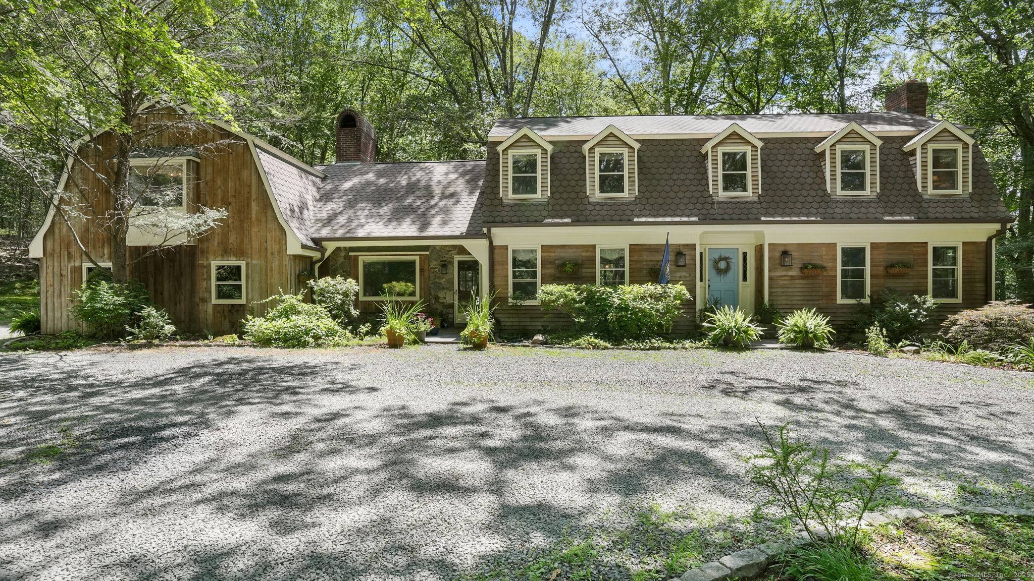 Tucked away at the end of a serene cul de sac, abutting protected land, is this timeless forever home.