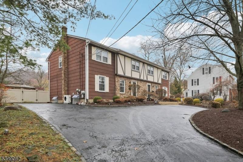 Spacious Totally Renovated Custom Tudor style duplex offering identical main level layouts on both sides, featuring a Living room, Formal Dining room, Modern Eat in kitchens with newer updates and ...