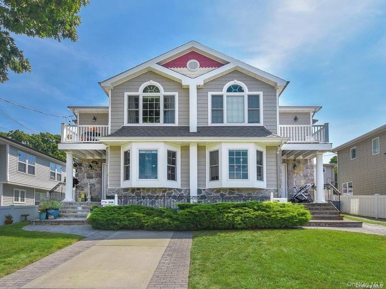 Water Views of Manhasset Bay from this spacious Duplex Unit A featuring living room, dining area, eat in kitchen with granite counters, SS appliances and sliders to backyard, and powder ...