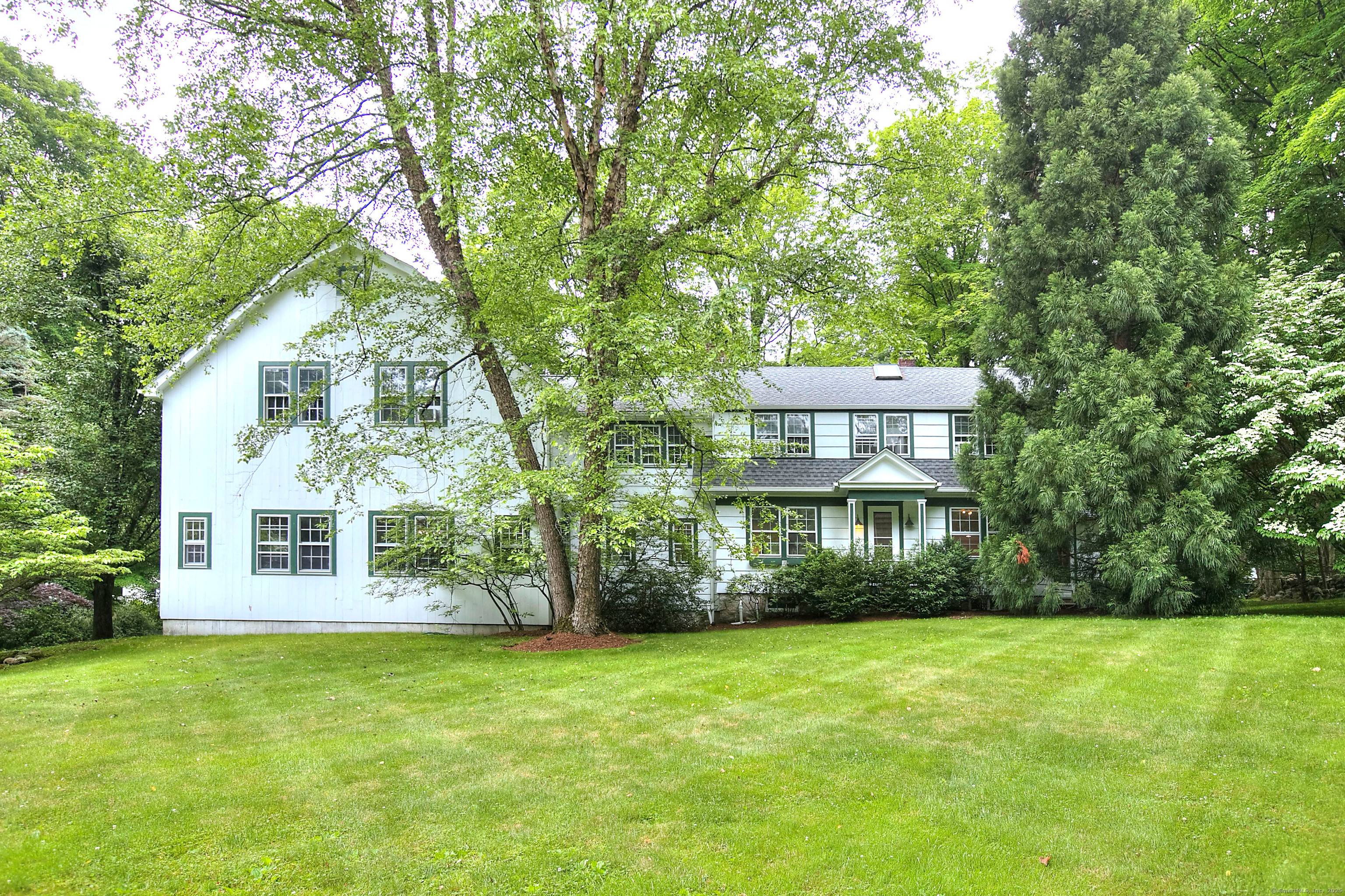 Quietly sited atop of a serene two acre lot, this wonderful home is a rare find.