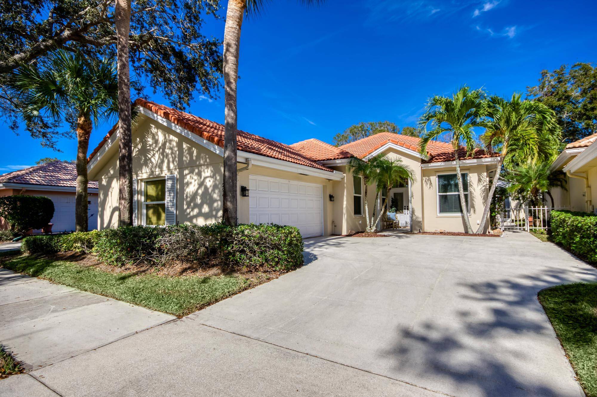 Enjoy the Florida lifestyle in this lovely one story home in Hamptons at Maplewood, a sought after tree lined community in the heart of Jupiter.