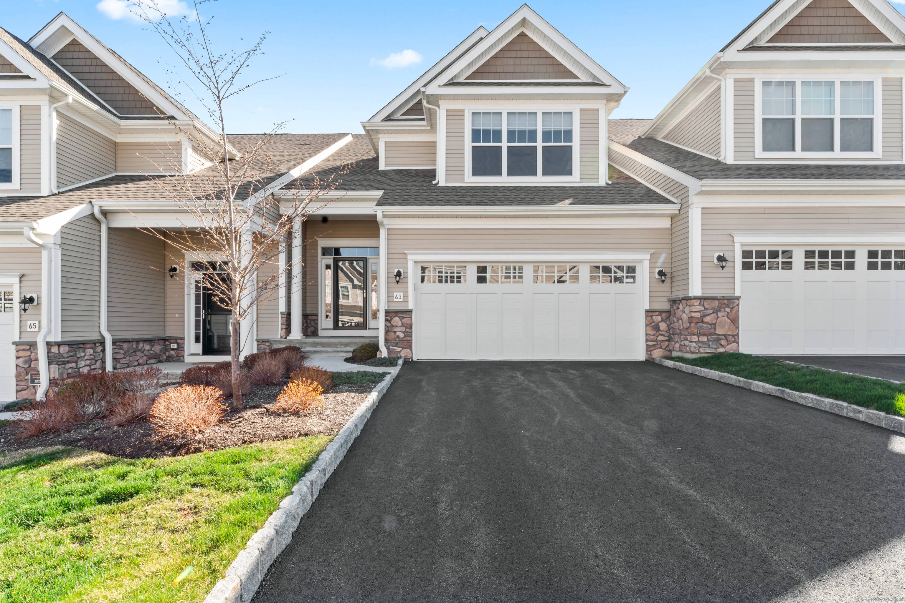 Welcome to 63 Great Hill Drive, a stunning townhome in The Summit at Bethel, a premier active adult luxury community with resort style amenities and maintenance free living.