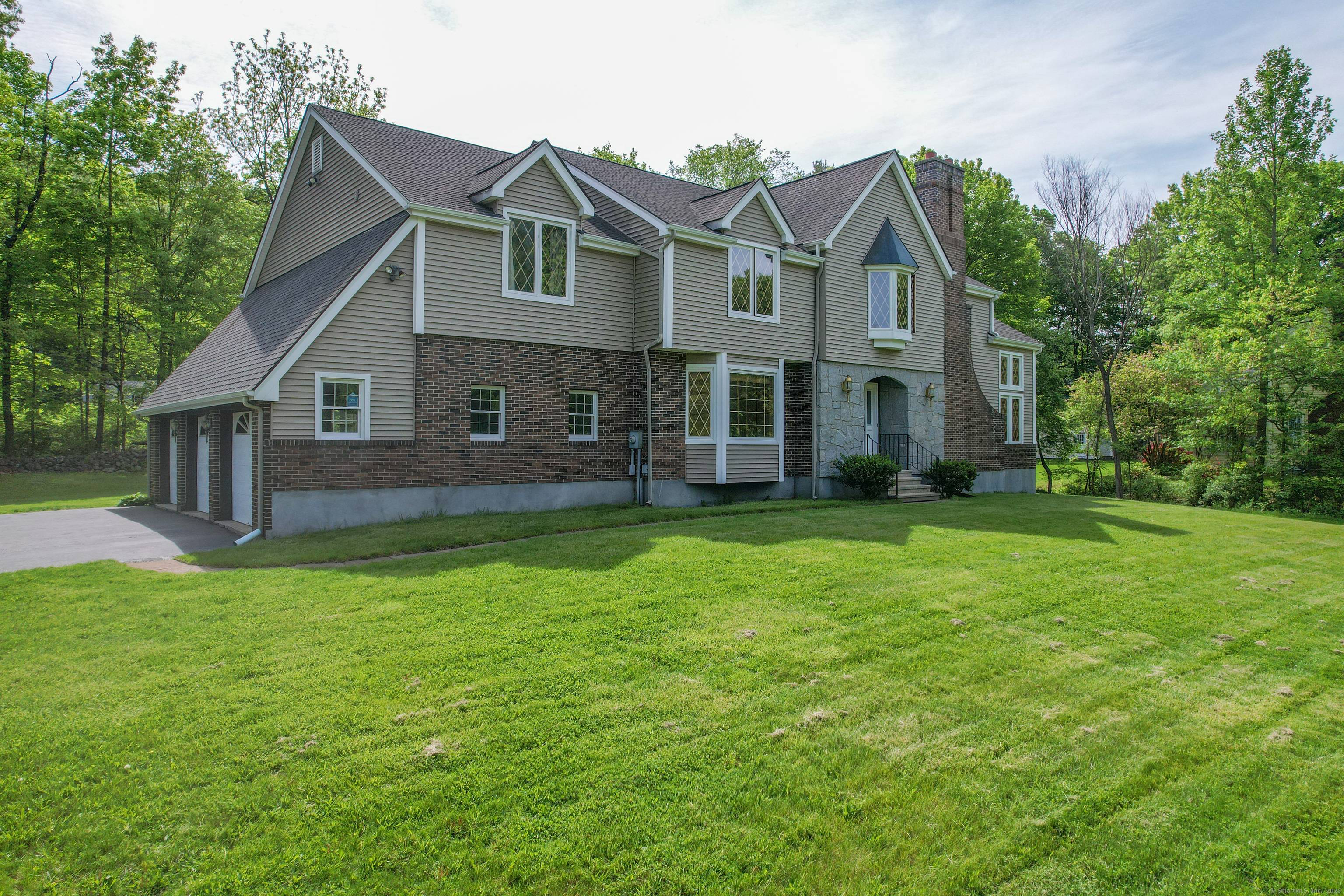 You'll be captivated the moment you pass through the stately stone pillars approach this stunning grand colonial, set on a picturesque lot in one of Southington's most desirable areas.
