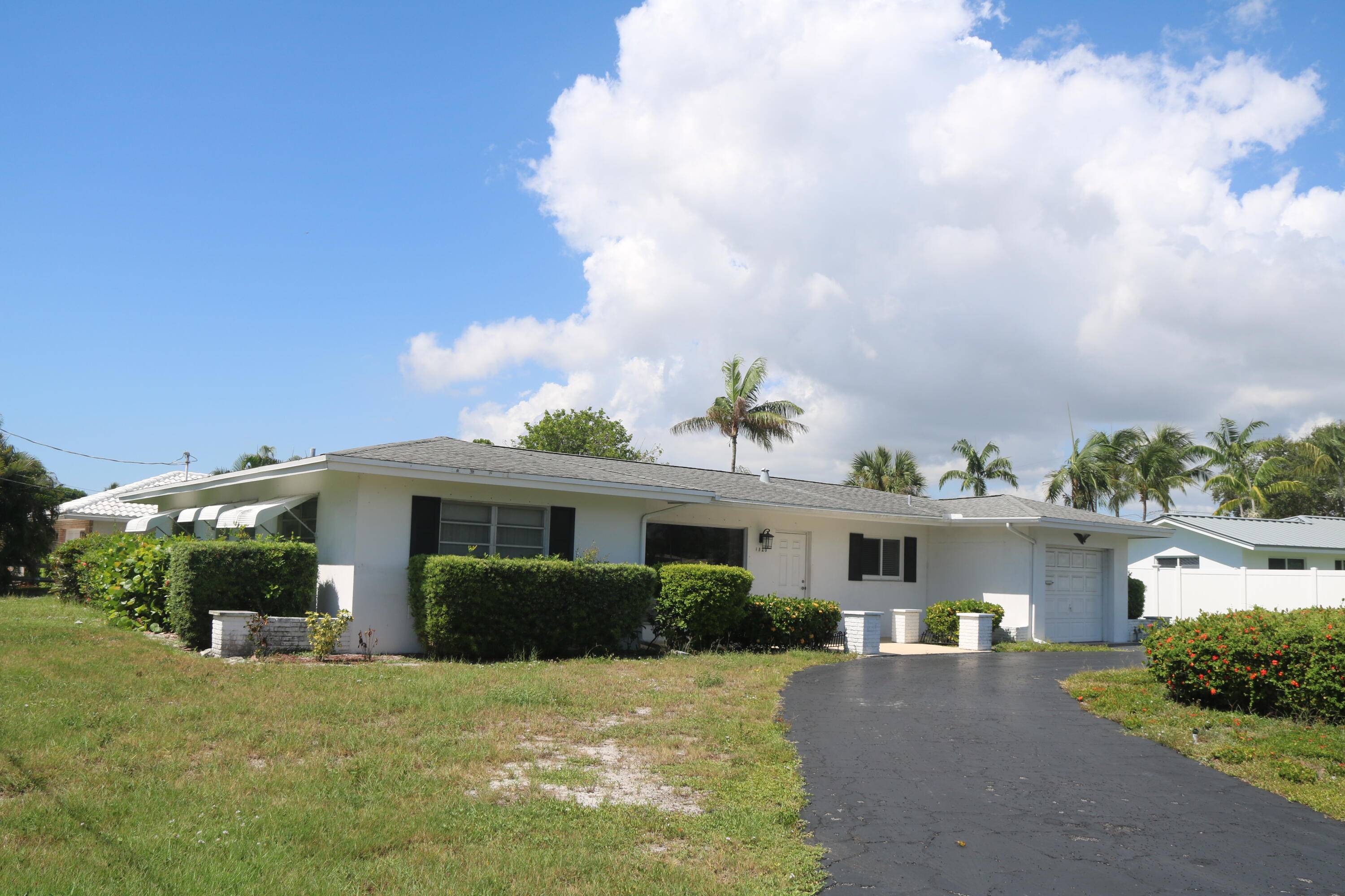 Welcome to this charming in Deerfield Beach, FL, nestled on an oversized corner lot within a welcoming community.