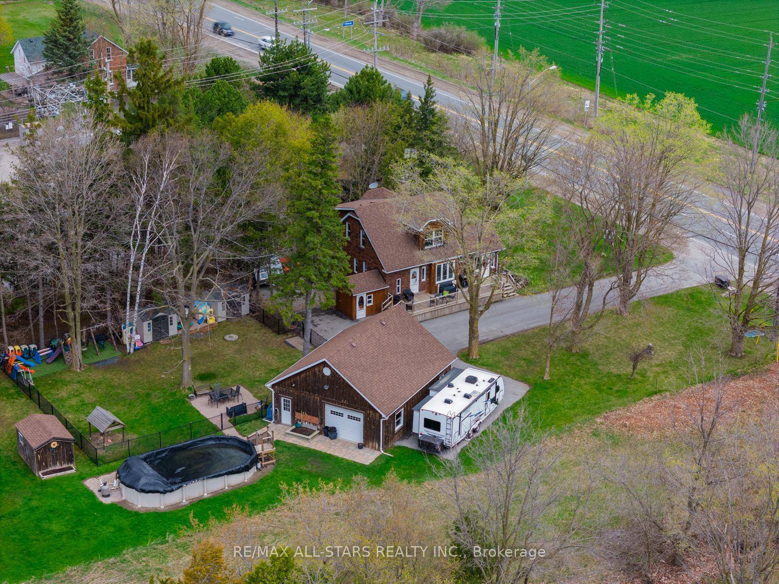 Rural Serenity Meets Urban Convenience in this 4 Bedroom Home with Workshop on an Expansive Lot !