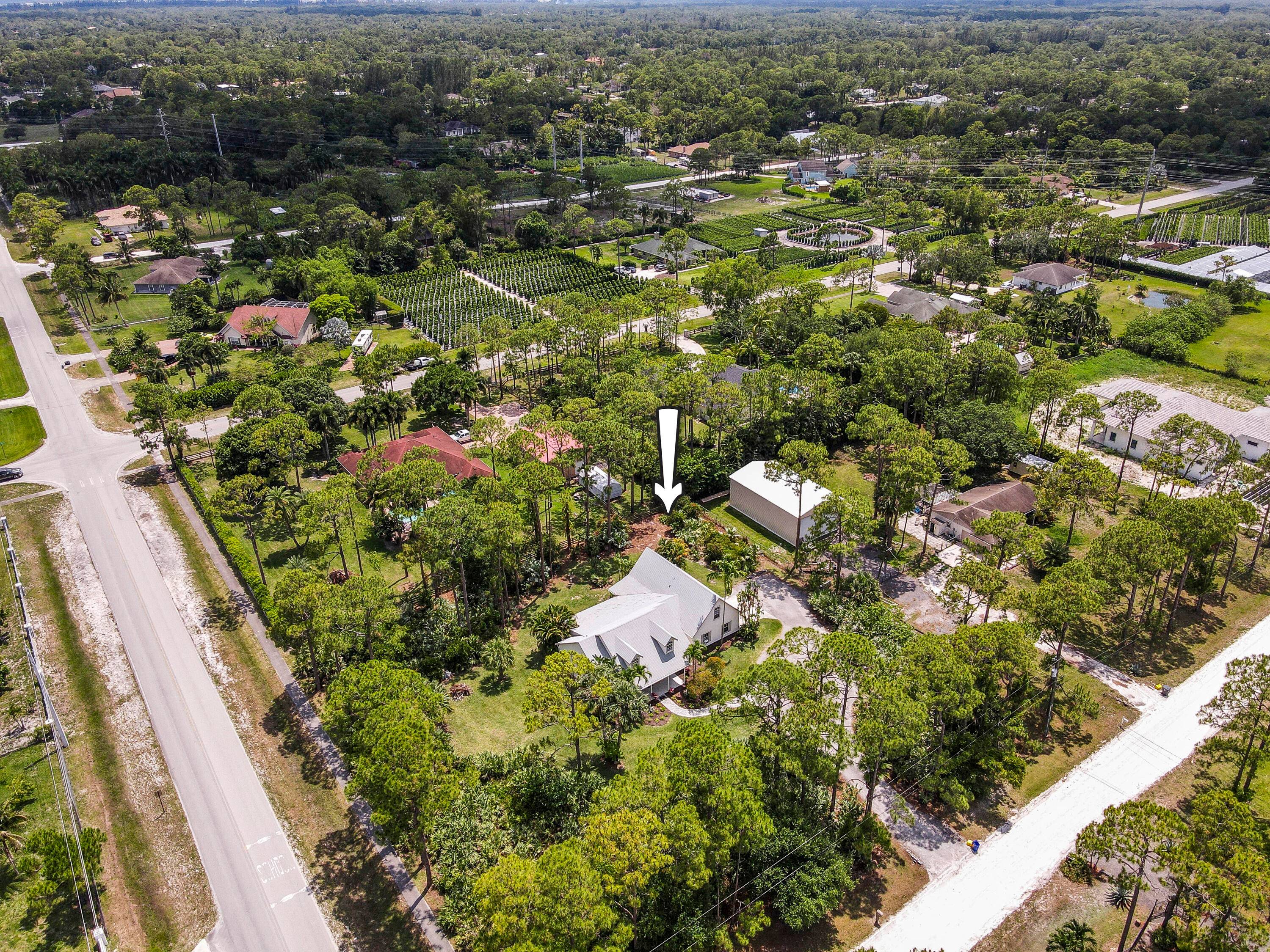 This charming, Farmhouse inspired Loxahatchee home sits on 1.