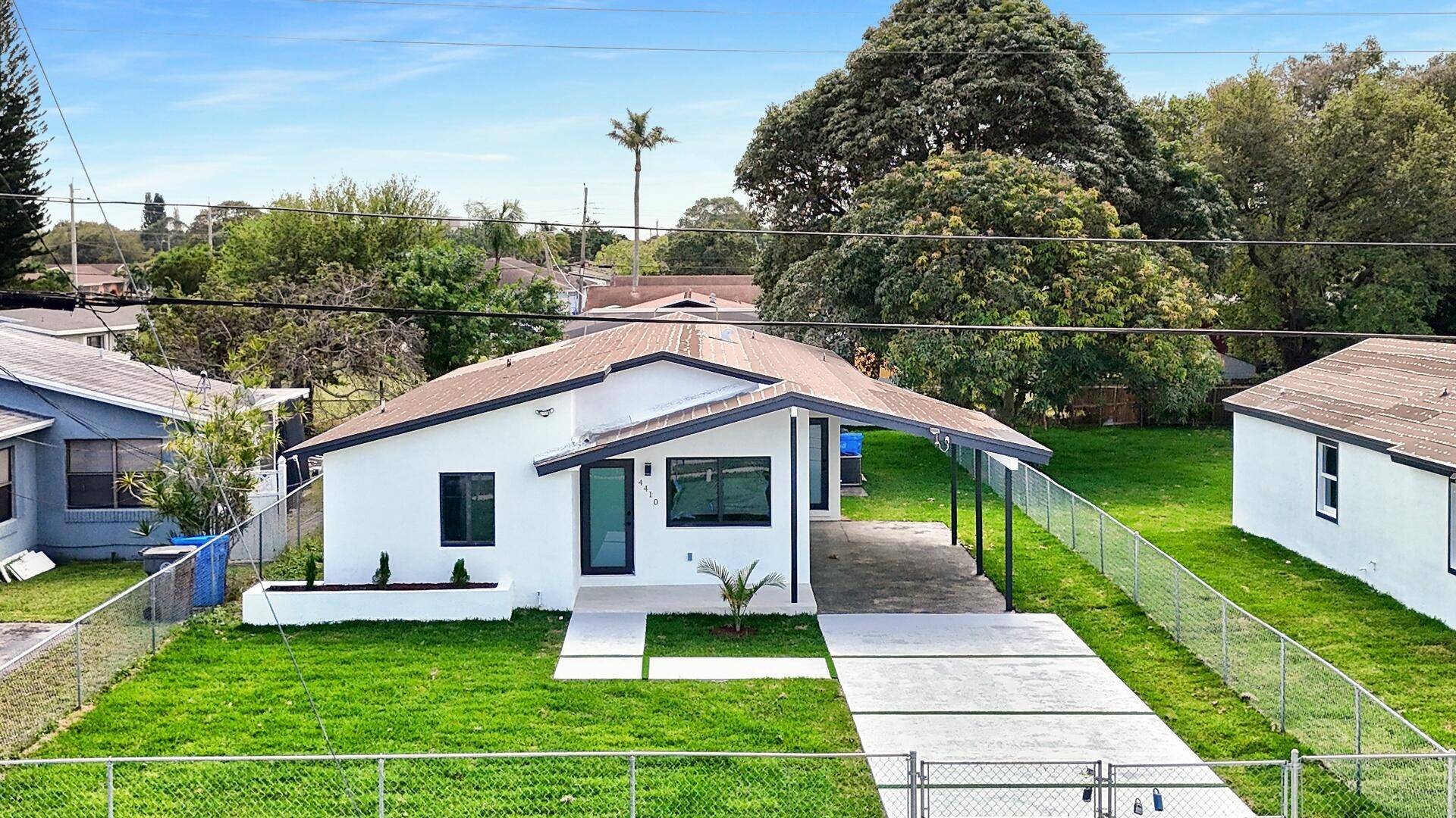 This beautifully updated home boasts an open floor plan with impact windows, neutral flooring, recessed lighting, and freshly painted walls, creating a bright and inviting ambiance.