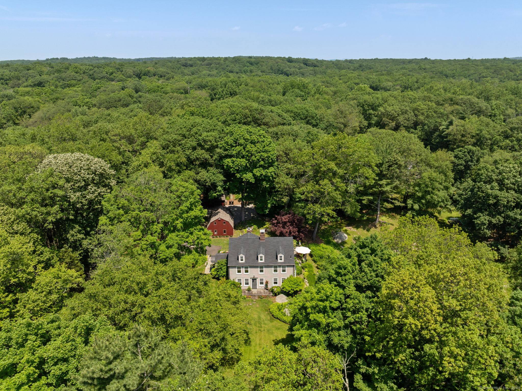 Timeless elegance and serene privacy define this beautifully renovated and expanded 1930s Colonial, peacefully set on over 4 acres of beautifully balanced meadow and woodland bordering the Weir Farm Nature ...