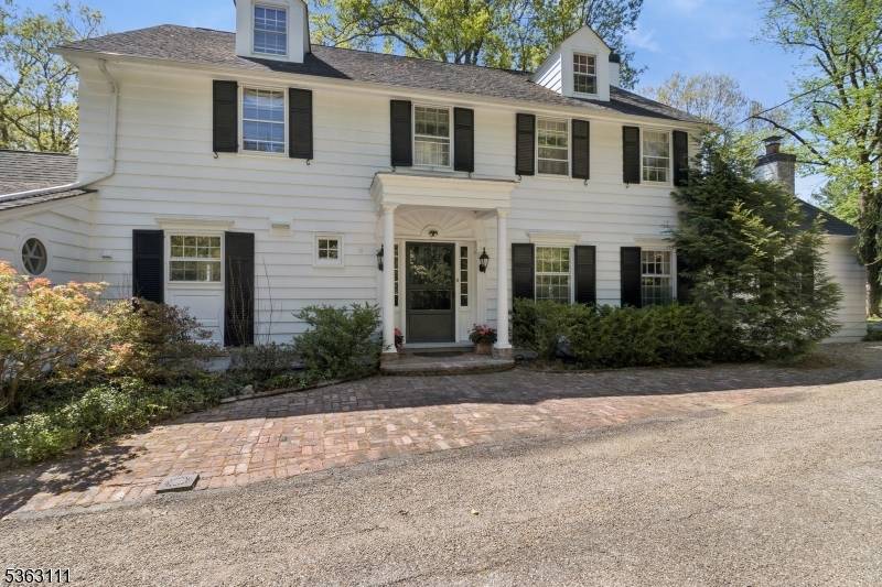 Located in one of Basking Ridge's most coveted locations, this timeless home features spacious rooms, quality construction with custom detail moldings, hardwood flooring, and 3 wood burning fireplaces.