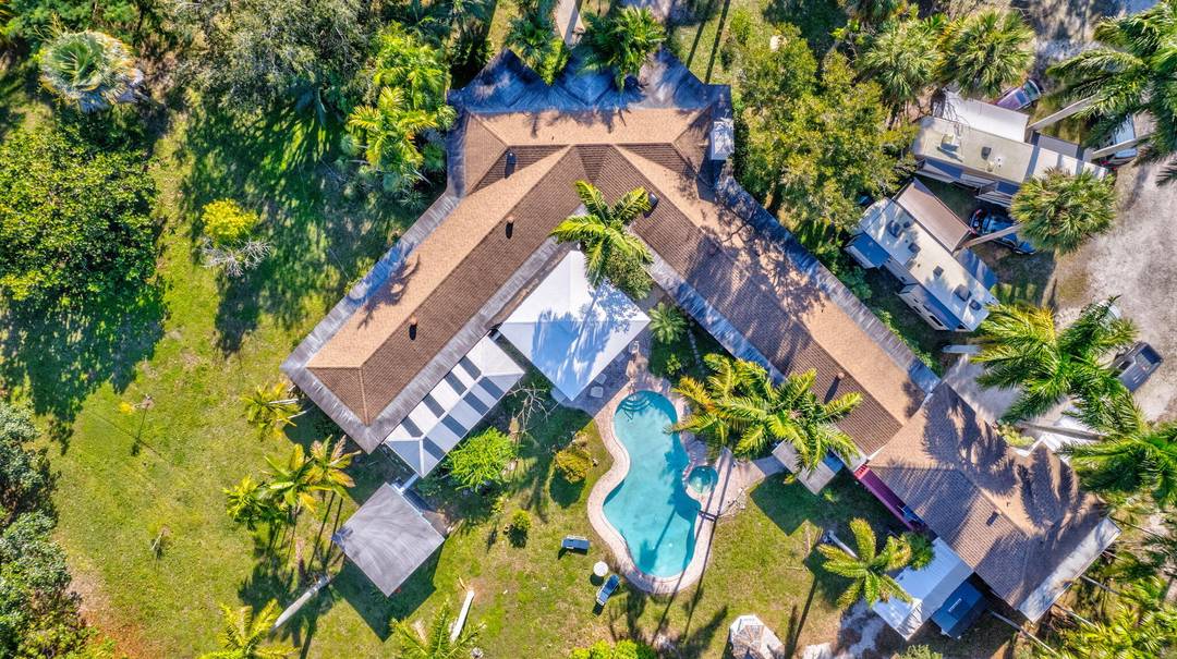 Rare 3. 3 acre private oasis and custom home, build 8 more homes, in Central West Palm Beach, offers exceptional seclusion, flexibility, and opportunity.