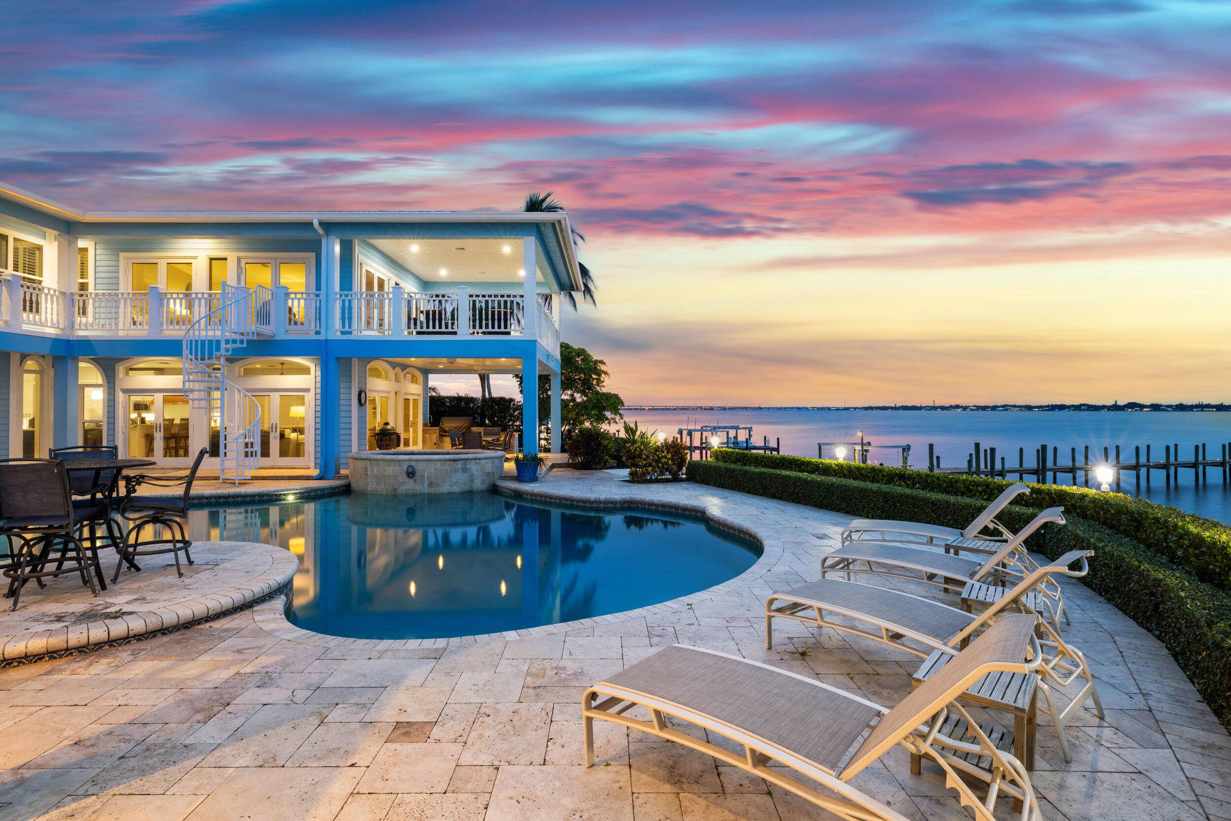Located on coveted Riverside Dr near downtown Stuart, this waterfront estate blends timeless design with modern luxury.
