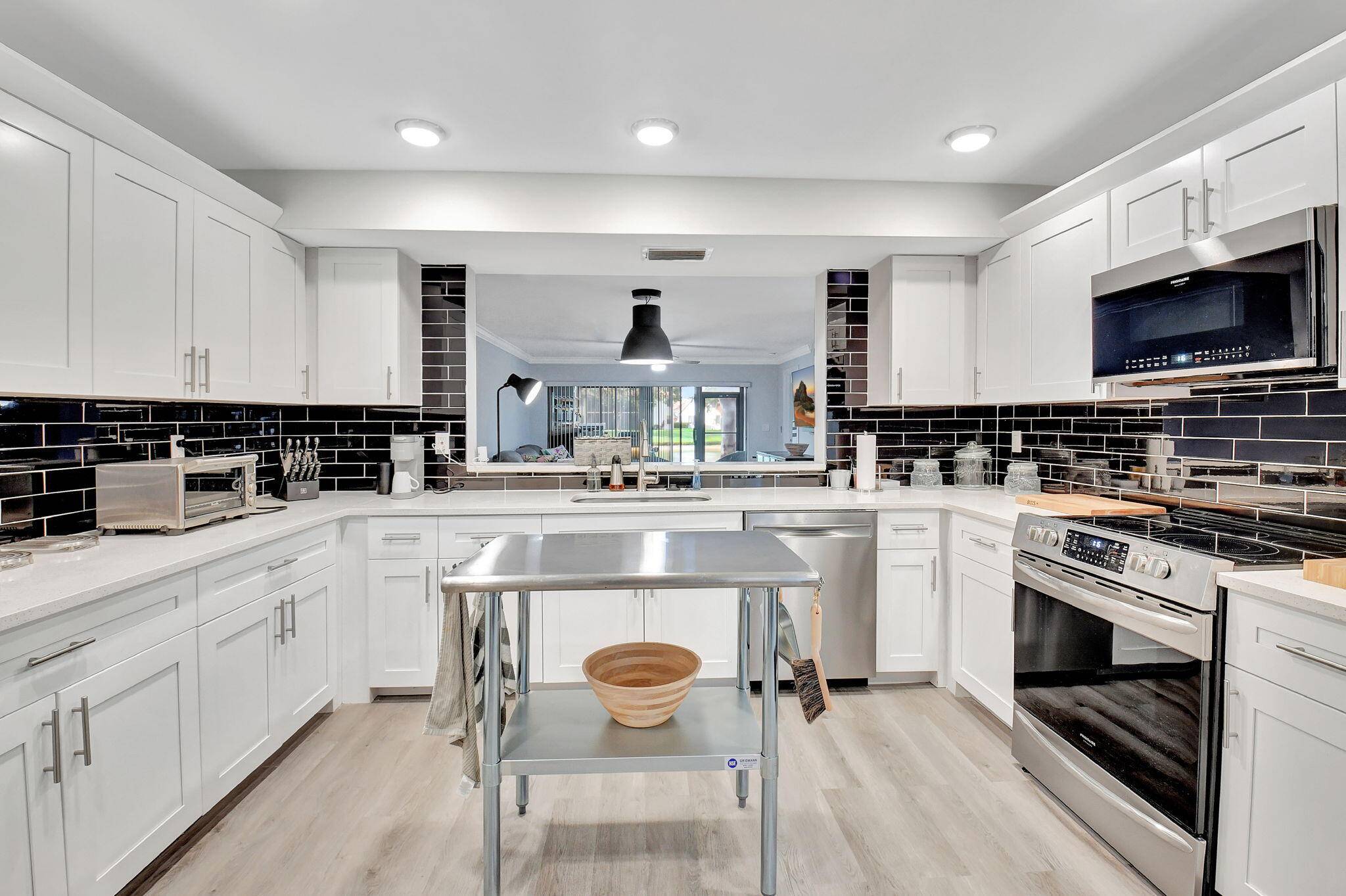 Stunning and completely renovated first floor condo with tremendous kitchen, bonus two walk in closets, High end appointments and both a screened covered patio and an outdoor patio !