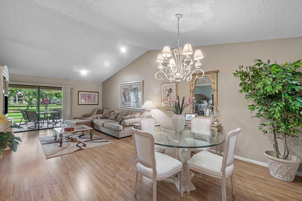 THE MOMENT YOU STEP INTO THIS VERY SPACIOUS CONDO, YOU NOTICE THE HIGH CATHEDRAL CEILINGS NEW HIGH END WOOD LAMINATE FLOORING THROUGHOUT !