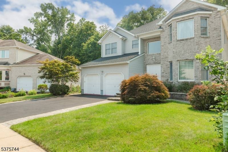 Mazdabrook brick front colonial on Flat lot, Open floor plan with 9 foot ceilings, bright Family Room with fireplace, Sliding glass doors to double deck, Private yard.