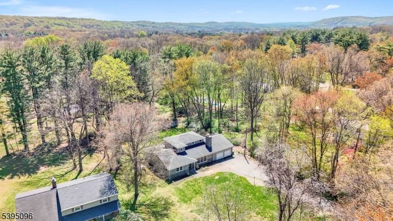 Modern updated expanded ranch set far back from the road with flexible primary suite on 1st floor or 2nd floor offers neutral colors, upgrades galore, finished basement, deck overlooking private ...