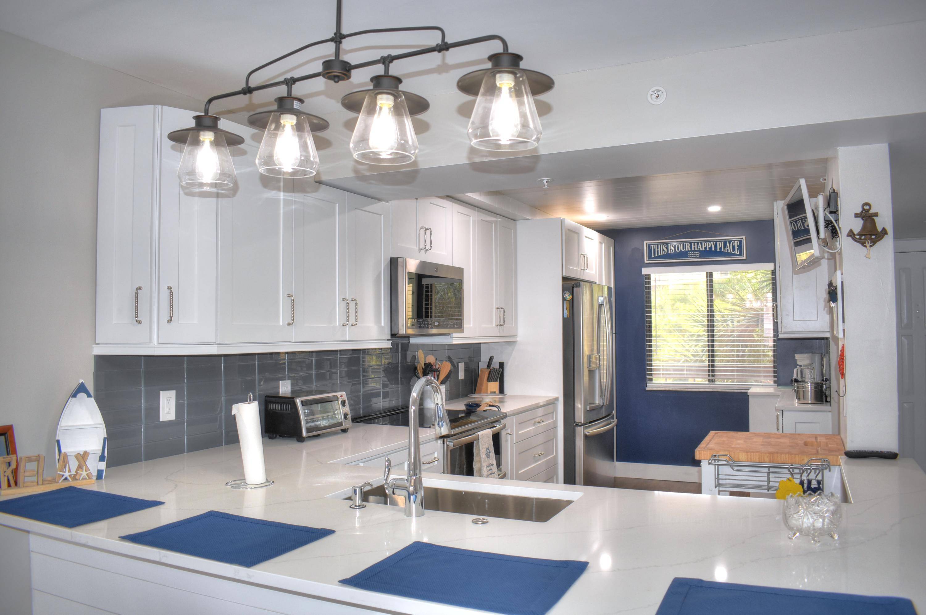 Completely remodeled ! New expanded kitchen, new baths, shaker white cabinets with quartz countertops.