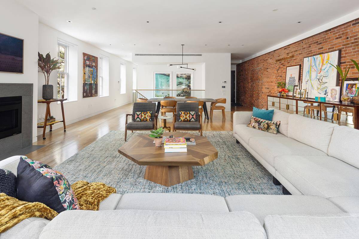 A corner triplex with five bedrooms, four baths, powder room, a windowed eat in kitchen, two working fireplaces, and a small garden.