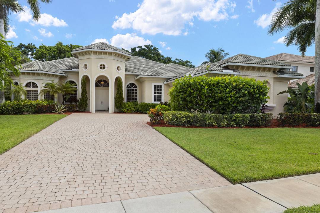 Located in the prestigious gated Equestrian Club community, this 5 bedroom den, 4.