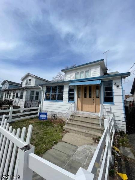 Income ready two family with metal siding, private parking, and a bonus porch, tucked on a quiet one way street just five minutes from the Garden State Parkway.