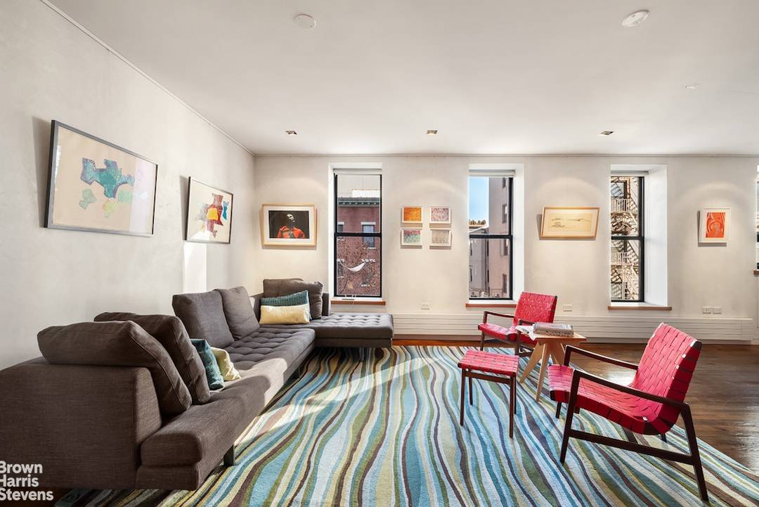 A rare find in the East Village Full floor loft in a boutique, pre war condo building, with key lock elevator, wood burning fireplace, and corner exposure with 17 windows ...