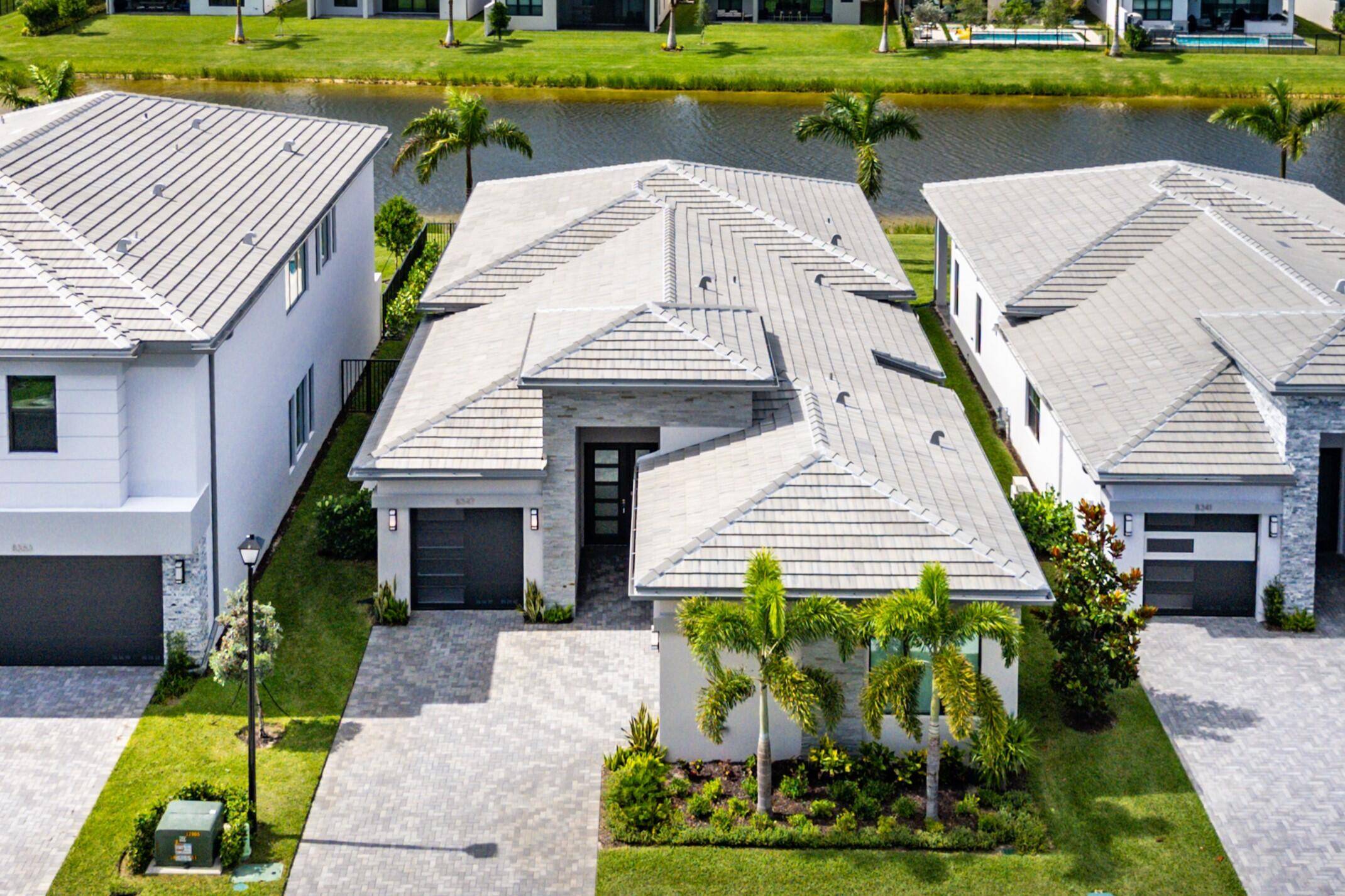 Perfectly finished, move in ready Bermuda one story home with pool on the lake in Lotus Palm ready for the most discerning buyer.