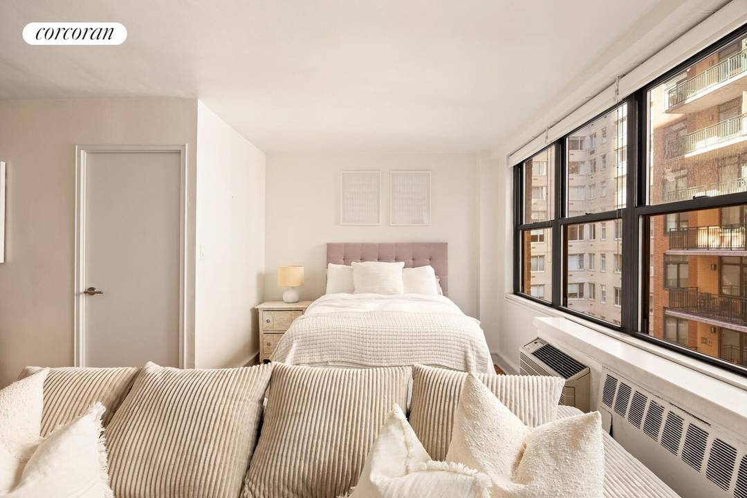 Updated and spacious alcove studio at 209 East 56th Street, a full service cooperative building in Midtown East's Sutton Place.
