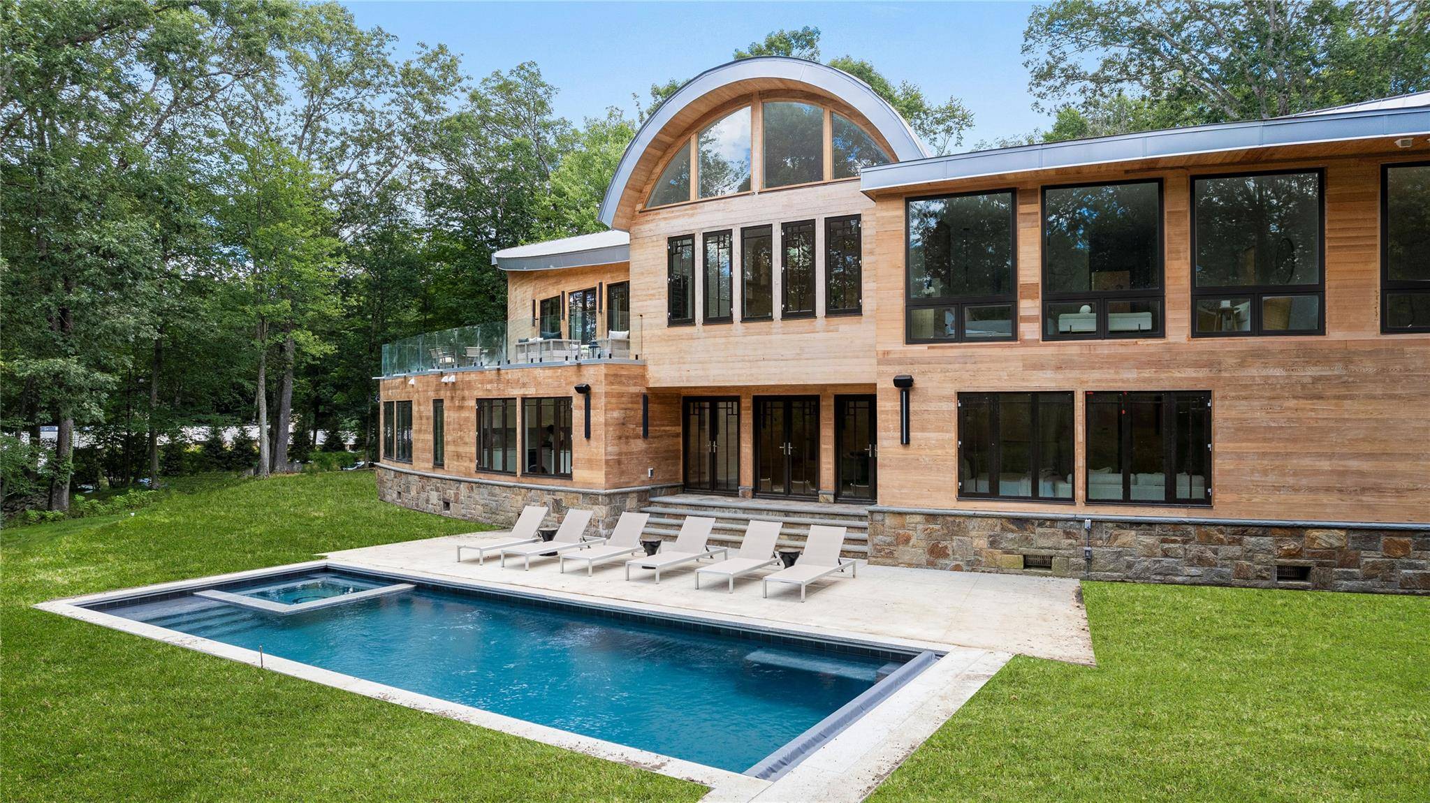 Welcome to 16 Col Sheldon, a newly completed and designer finished modern masterpiece set on four private acres in the heart of Pound Ridge.