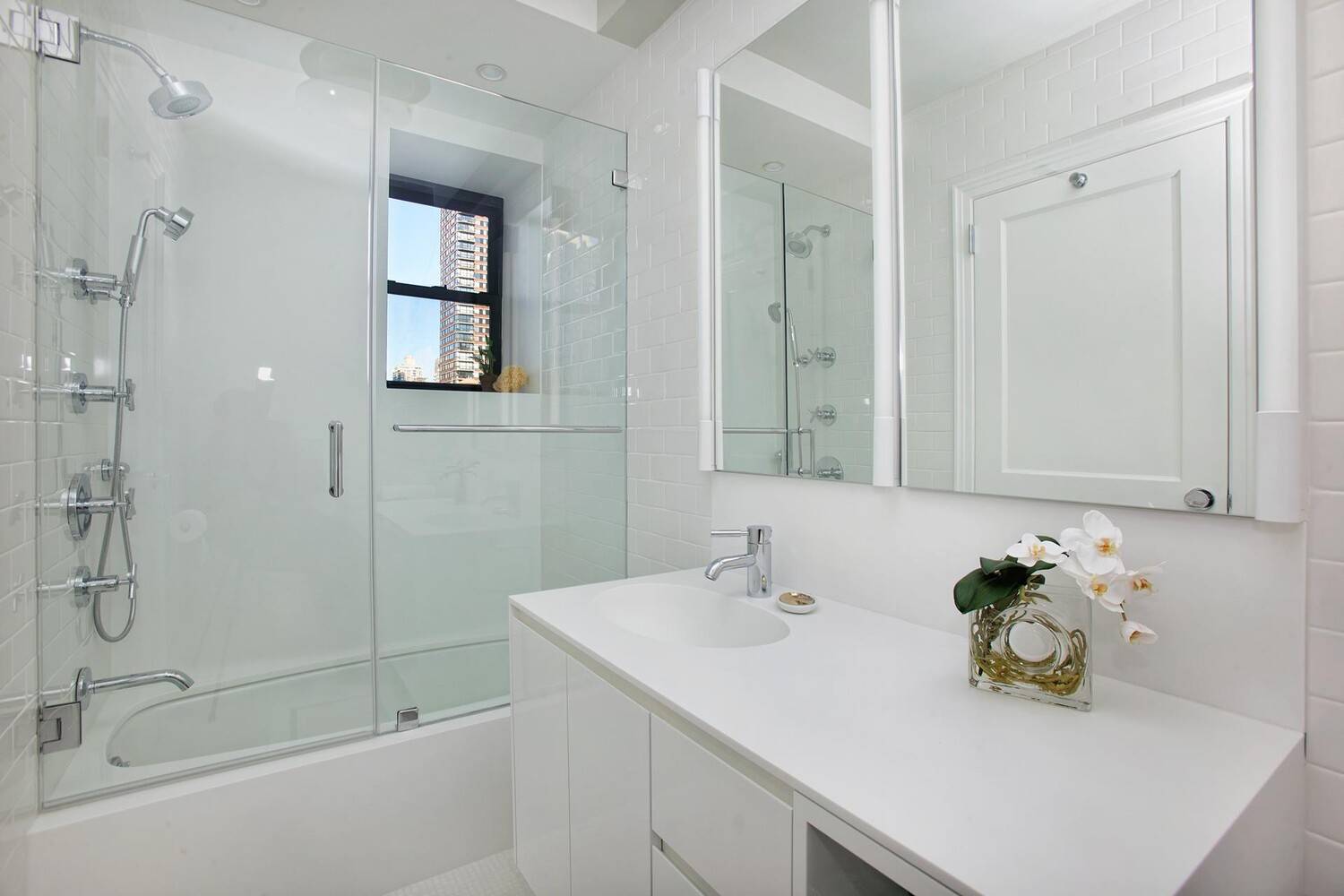 SUNNY, SLEEK AND CHIC This absolutely stunning, meticulously renovated 2 bedroom, 2 bathroom prewar home is flooded with natural light and overflowing with both 1920s character and 2020s understated elegance.