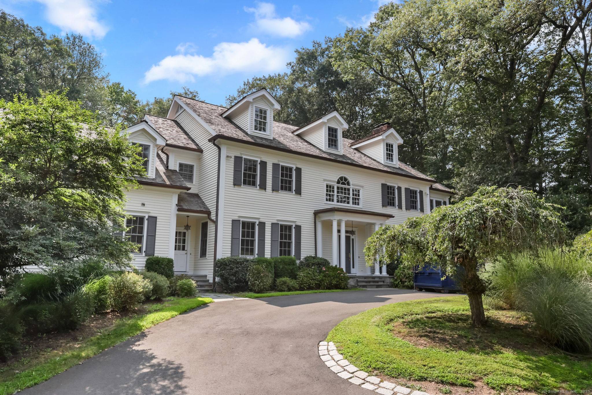 Gracious center hall colonial set back from road.