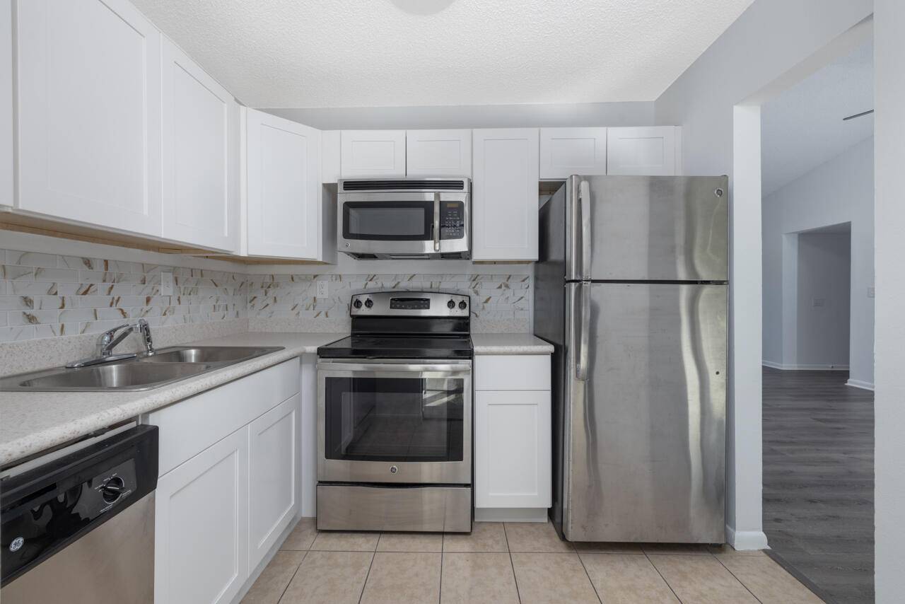 Welcome to your captivating 2 bedroom, 2 bath, second floor condo that features a NEW 2021 METAL ROOF and offers the perfect blend of comfort and coastal living.