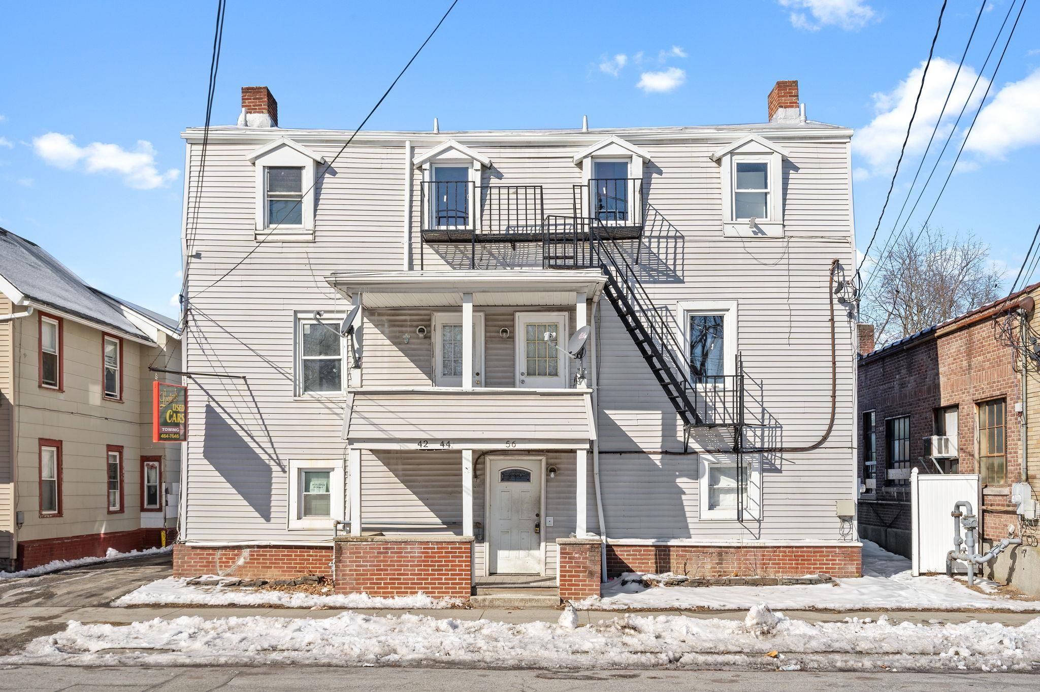 Fully available 6 unit residential building with a rentable 2 bay Garage currently used a mechanic shop.