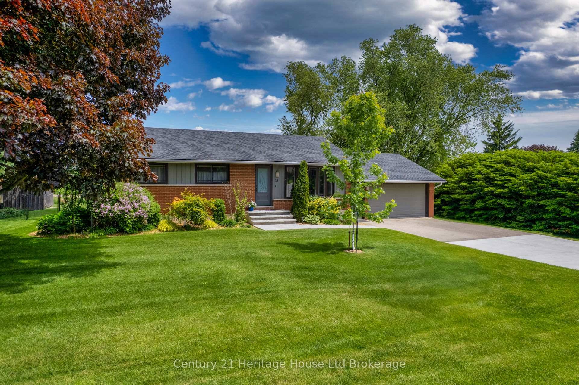 Welcome to 35 Tanager Dr, an exquisitely updated, turnkey bungalow nestled on one of the most generous and meticulously landscaped lots in the area.