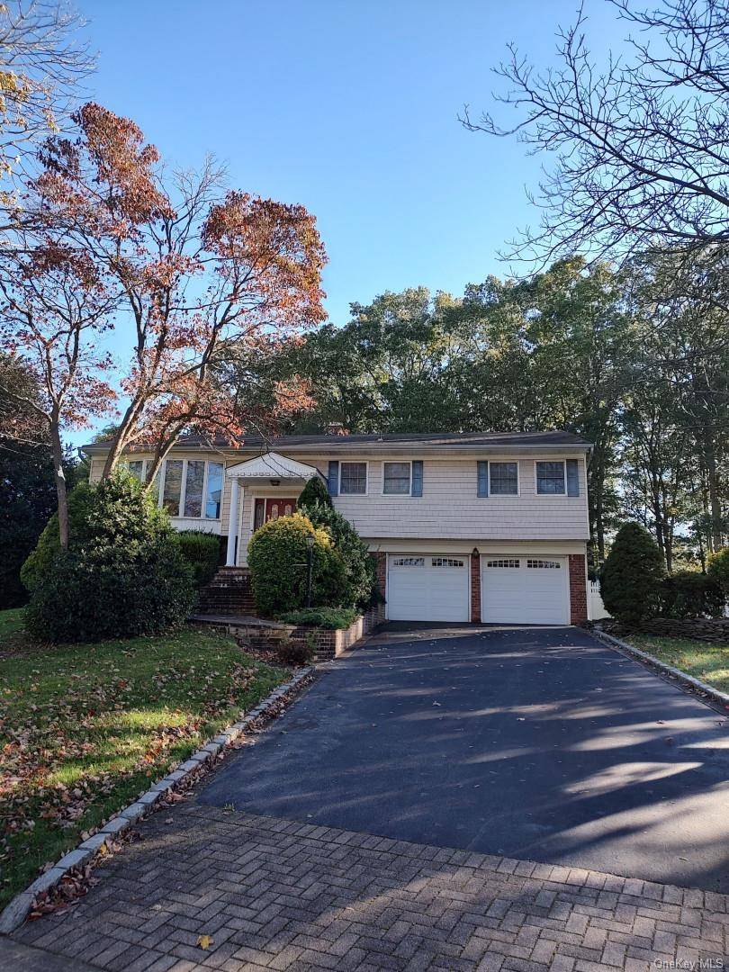 Spacious 4 bedroom Hi Ranch featuring master bedroom with bath and walk in closet, 3 additional bedrooms upstairs.