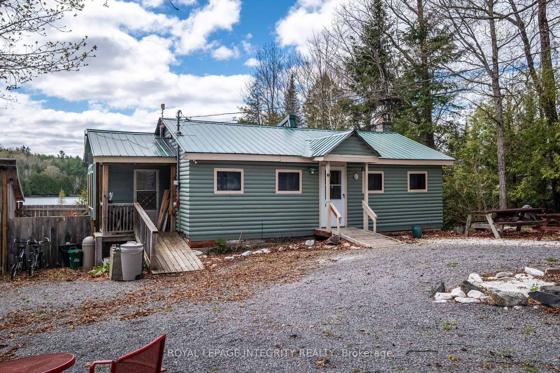 This log sided cottage sits on a pristine lakefront on Robbs Lake, offering stunning views and peaceful surroundings.