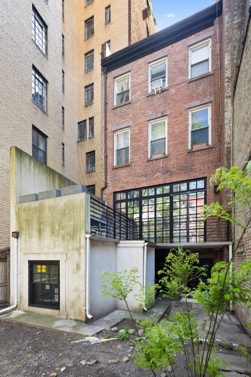 For sale is a luxury multi family townhouse that includes five studios and a triplex with two bedrooms and one and a half bathrooms.