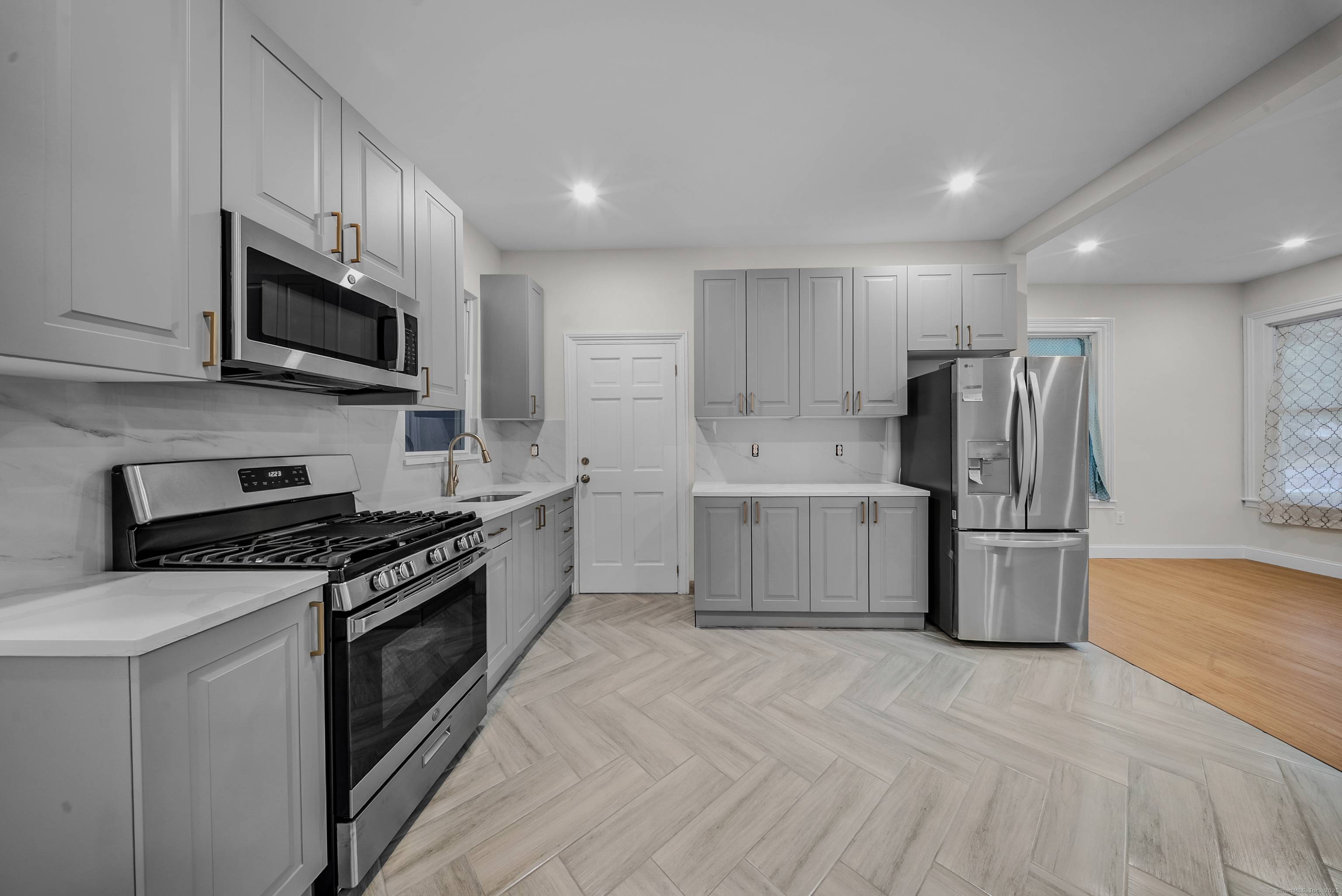Recently updated 2 family house situated on a leveled corner lot featuring laundry hook ups in each unit, beautiful hardwood floors, and split units for efficient heating and cooling.
