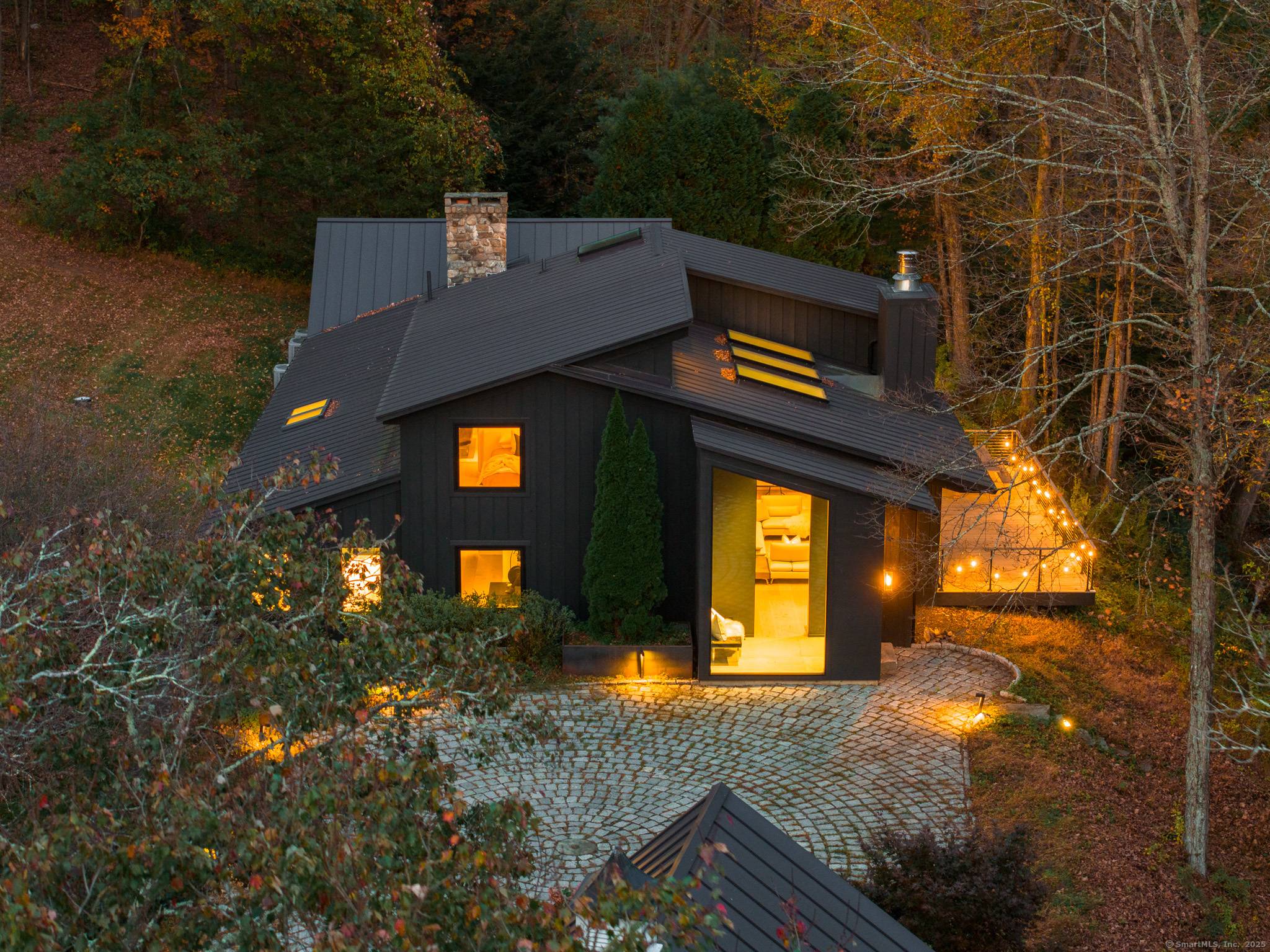 67 Squire Road blends striking modern architecture with timeless New England character on nearly 11 private acres in Roxbury.