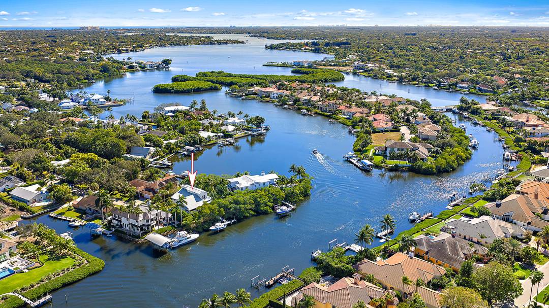 This gorgeous riverfront home boasts 100 feet of water frontage, sweeping views, and a dock with a 12, 500 lb boat lift.