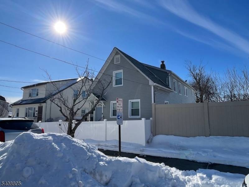 Two family home recently updated in a quiet street yet close to stores, schools, public transportation highways THREE car garage with parking for an add'l 8 cars access from S.