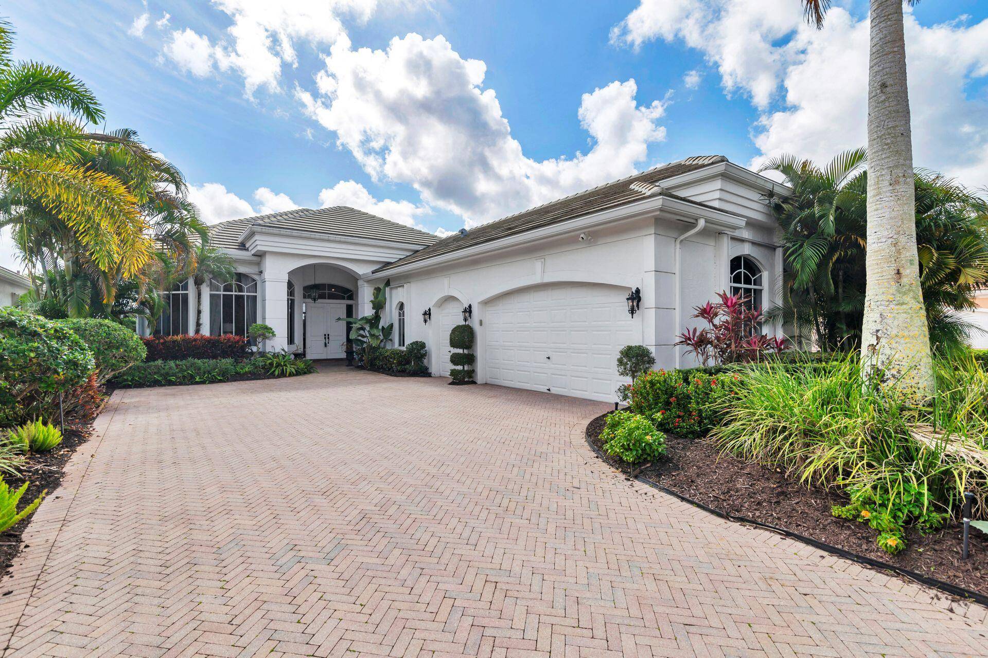 Mediterranean style home features 3BR 4FB, along with screened in lanai pool and picturesque golf courseviews.