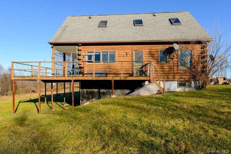 Nestled in the charming countryside of Montgomery, New York, 645 Bouleville Road is a picturesque log home brimming with rustic charm.