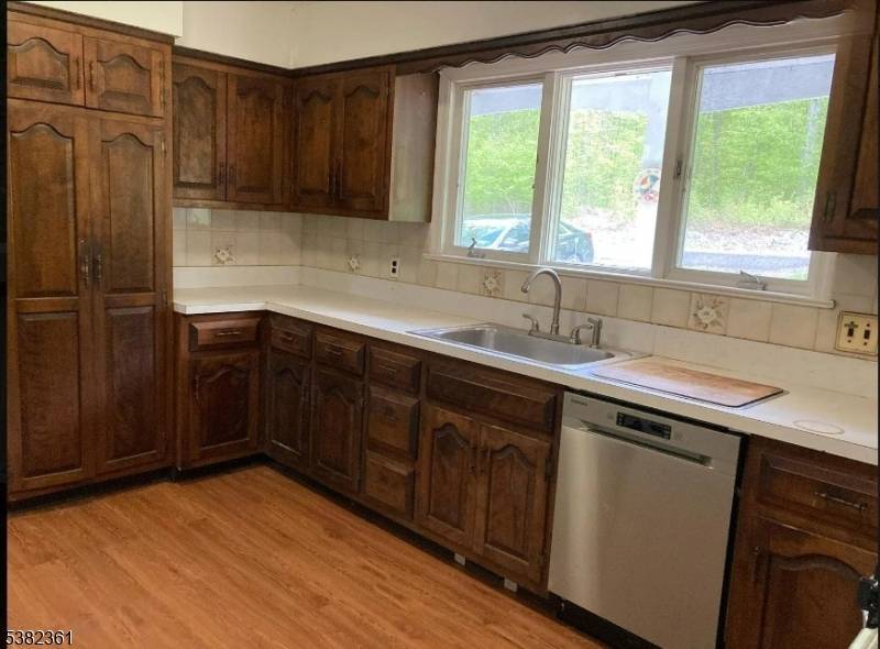 Great potential awaits with this Greenwood Lake ranch in desirable Awosting, perfectly set on a wooded lot just blocks from the lake.