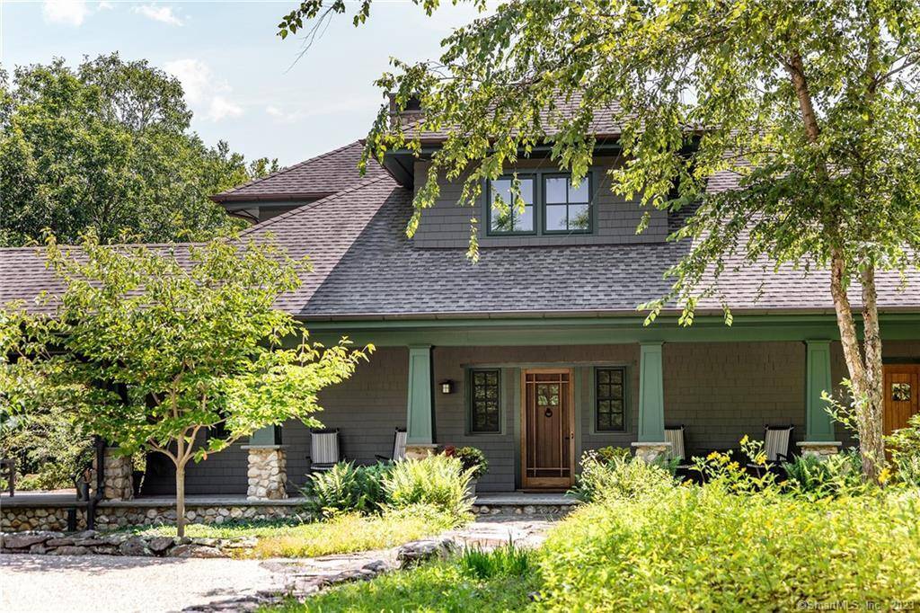 Tucked along Big Cove on Lake Quassapaug, this custom architect designed Arts Crafts bungalow is privately set on 14.